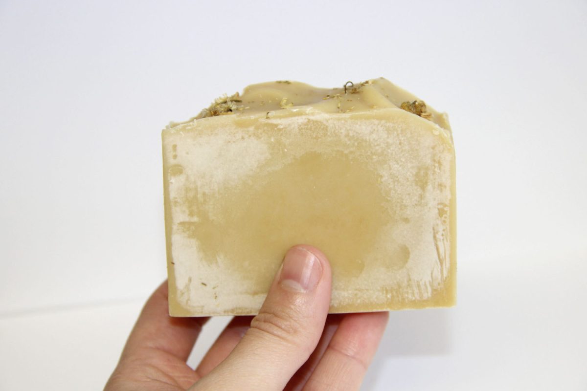 White soda ash film on the surface of a handmade cold process soap bar