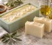 Cold process soap bars beside a silicone mold and soap-making oils on a worktable